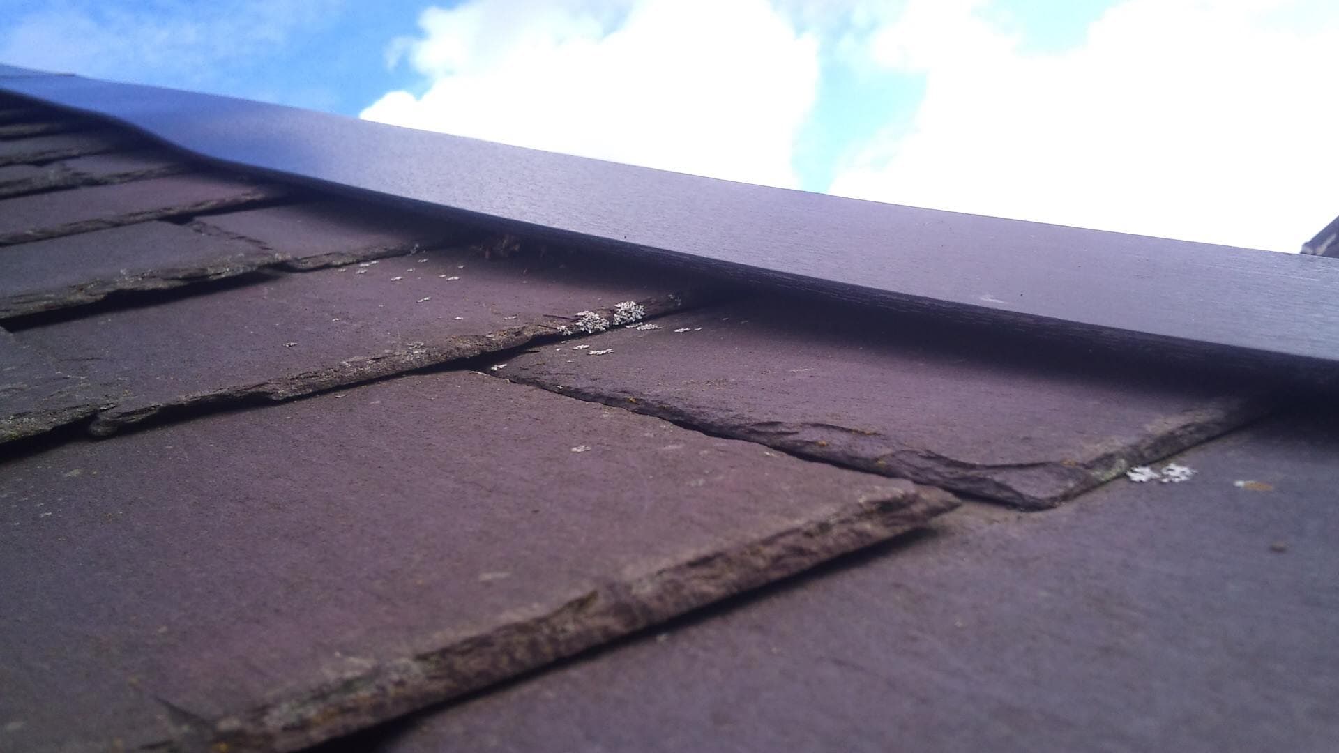 A roofer carrying out a roof repair in Leeds